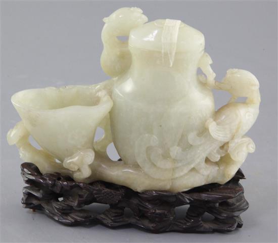 A Chinese pale celadon jade phoenix vessel, 18th / 19th century, 10.5 x 14.5cm, original carved wood stand, slight faults